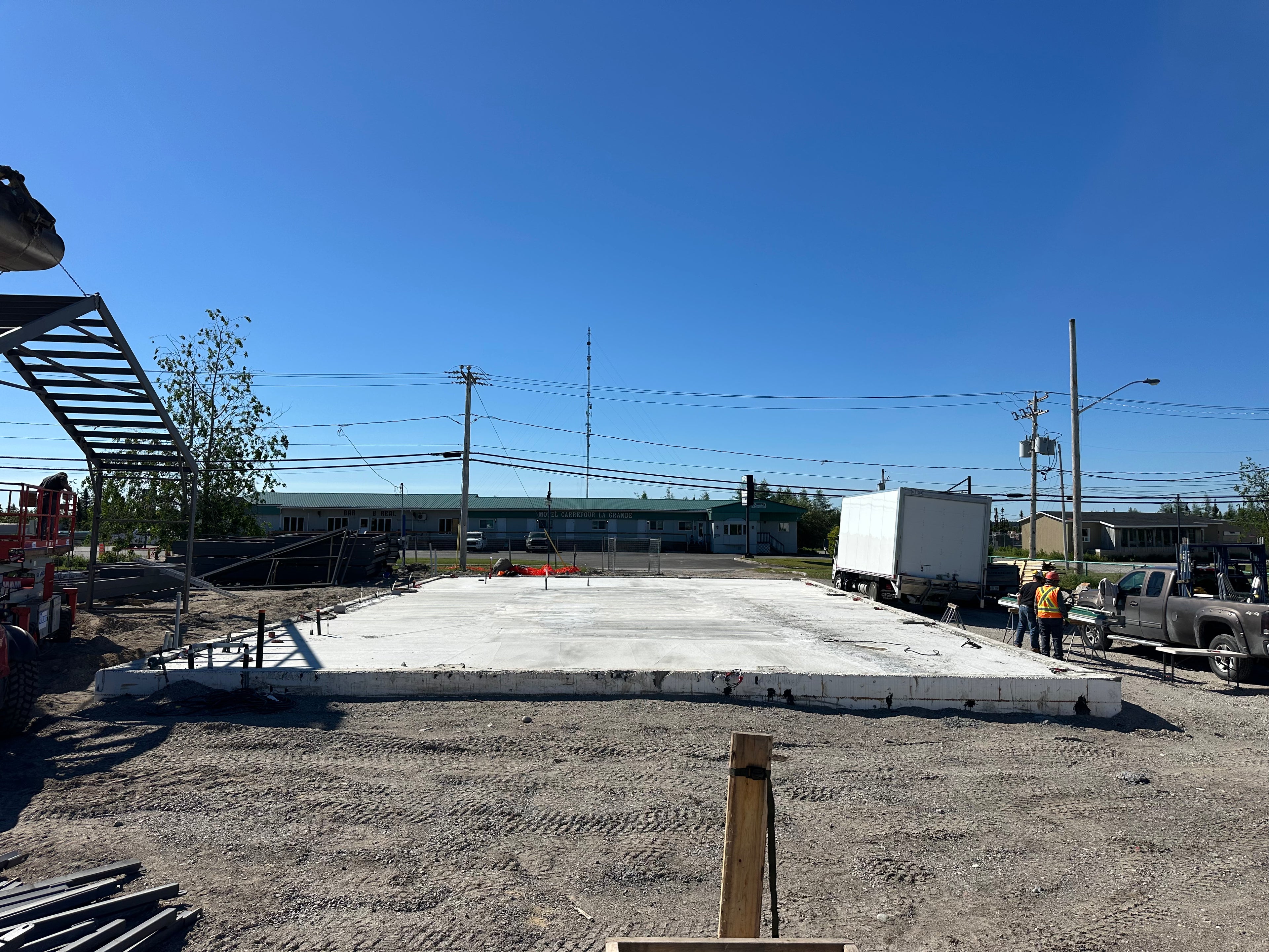 Construction site with a large concrete slab on a clear day